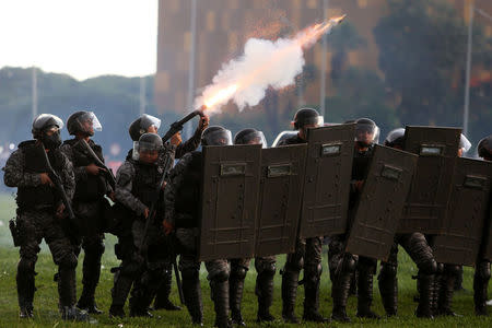 Riot policemen fire tear gas canisters during a clash with demonstrators during a protest against a constitutional amendment, known as PEC 55, that limits public spending, in front of Brazil's National Congress in Brasilia, Brazil November 29, 2016. REUTERS/Adriano Machado