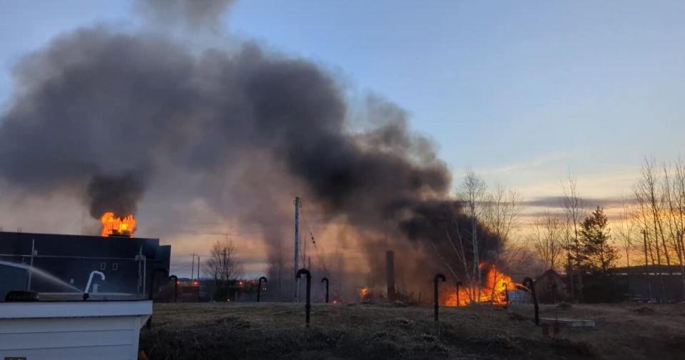 Smoke cascades over abandoned buildings at the former airport of Happy Valley-Goose Bay on Friday. 