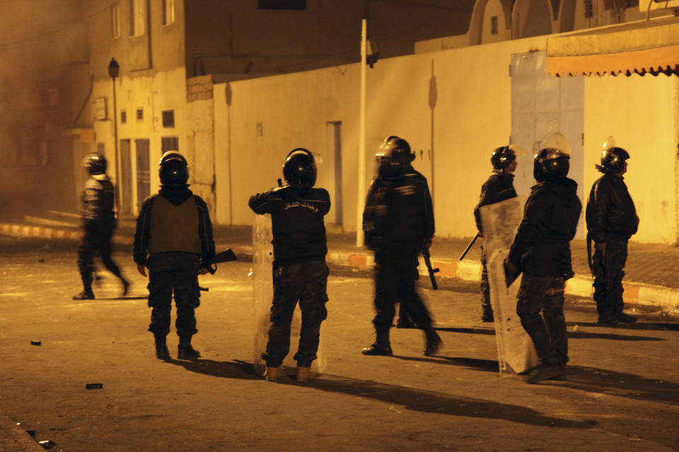 Tunisian Police officers patrol after clashes in the streets of Kasserine, southern of Tunisia, Wednesday, Dec 26, 2018.The death of a Tunisian journalist Abderrak Zorgui who set himself on fire to protest economic problems in the North African nation prompted a protest that led to clashes with police and nationwide concern. (AP Photo/Walid Ben Sassi)