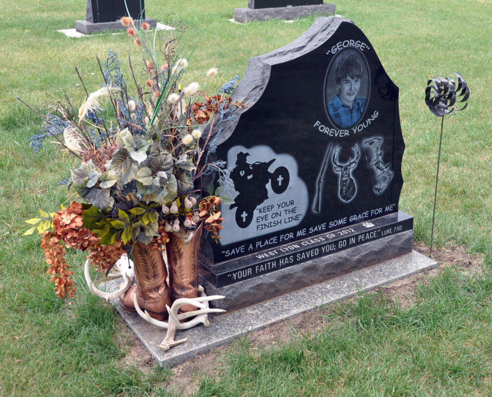 The back of a gravestone for Jordan Monen, who was killed last year in a farm accident, depicts his love of dirt bikes and hunting, Wednesday, June 20, 2012, in a cemetery in Lester, Iowa. (AP Photo/Dirk Lammers)