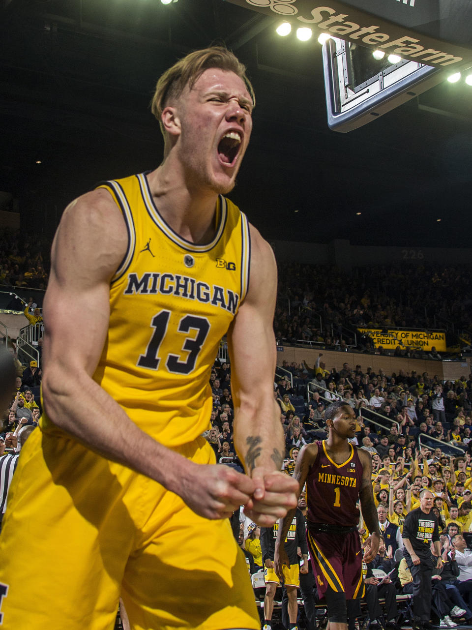 Michigan forward Ignas Brazdeikis (13) reacts to earning a free throw after making a basket in the second half of an NCAA college basketball game against Minnesota at Crisler Center in Ann Arbor, Mich., Tuesday, Jan. 22, 2019. Michigan won 59-57. (AP Photo/Tony Ding)