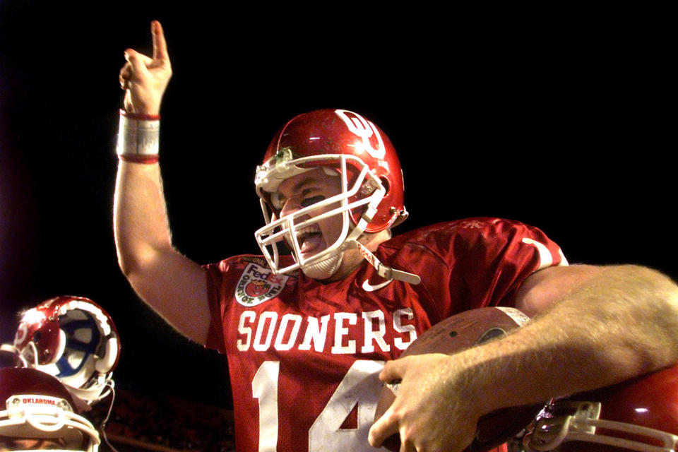 FILE - In this Jan. 3, 2001, file photo, Oklahoma quarterback Josh Heupelis carried off the field by his teammates after defeating Florida State 13-2 in the Orange Bowl in Miami. Heupel, who was the Heisman Trophy runner-up for Oklahoma in 2000, and former North Carolina pass-rushing star Julius Peppers are among 12 players making their first appearance of the College Football Hall of Fame ballot this year.(Greg Lovett/Palm Beach Post via AP, File)