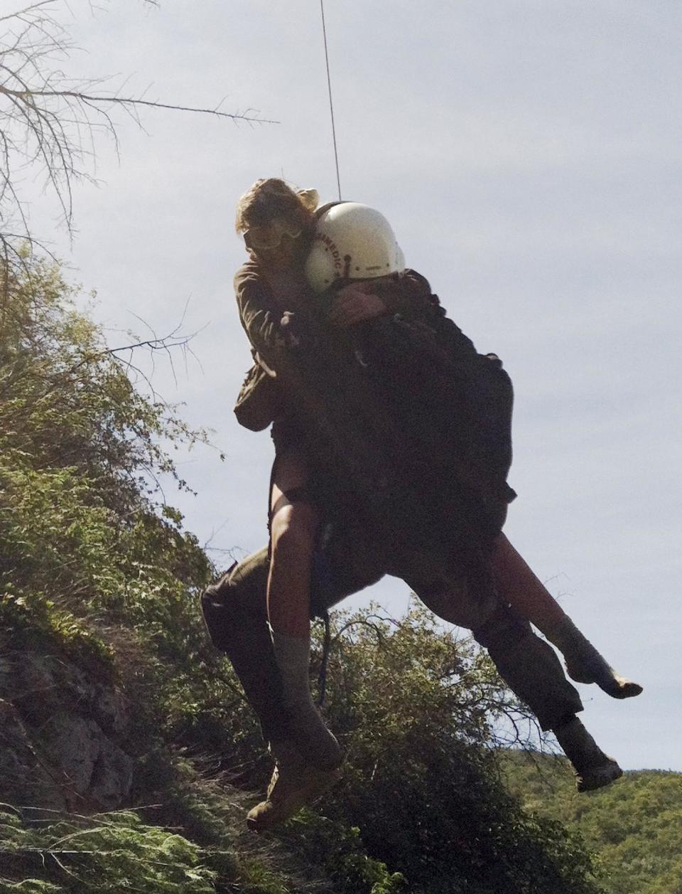 This photo provided by Los Angeles County Search and Rescue Reserve Deputy Doug Cramoline shows the helicopter rescue of Kyndall Jack, 18, by an L.A. County deputy after being missing for five days in rugged country near Rancho Santa Margarita, Calif., Thursday, April 4, 2013. A rescue team followed the sounds of a screaming female voice to an almost vertical canyon wall where they found Jack clinging to a rocky outcropping after going missing during a last Sunday. (AP Photo/L.A. County Search and Rescue Reserve, Deputy Doug Cramoline)