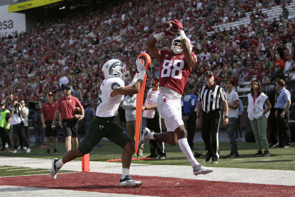 Washington State wide receiver De'Zhaun Stribling, right, catches a pass for a touchdown while defended by Colorado State defensive back Brandon Guzman during the first half of an NCAA college football game, Saturday, Sept. 17, 2022, in Pullman, Wash. (AP Photo/Young Kwak)