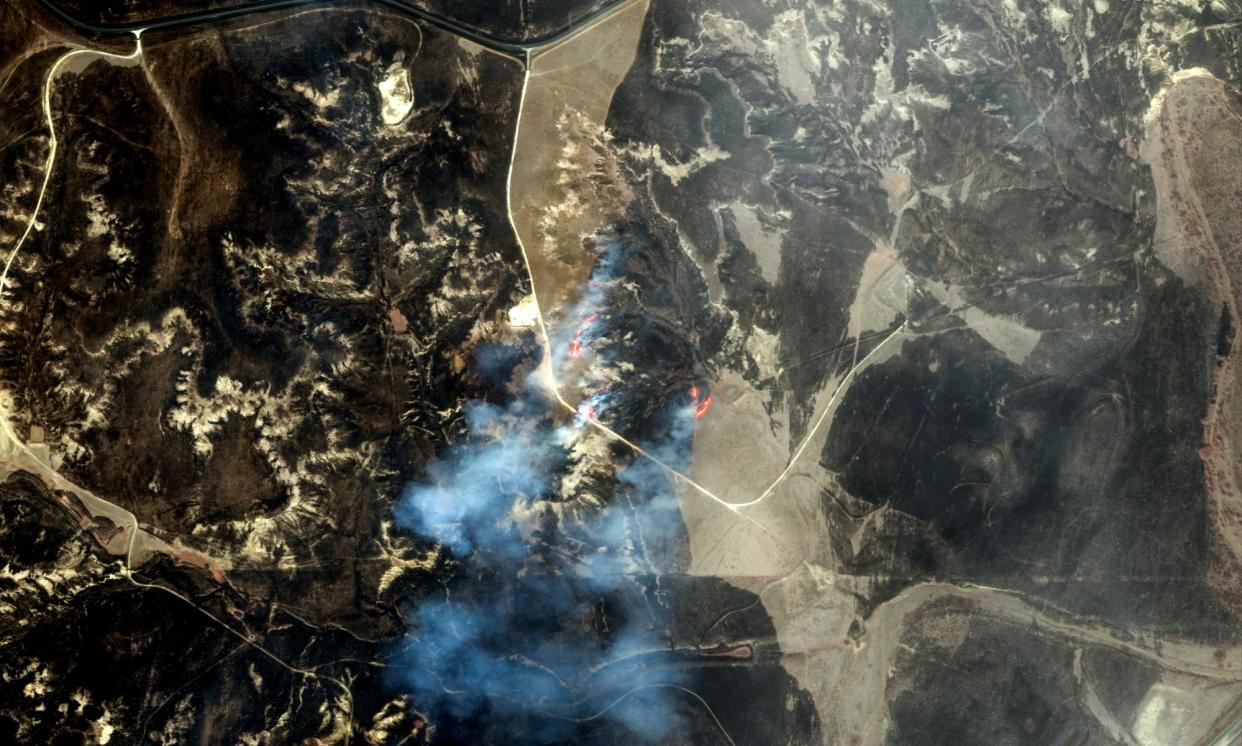 <span>This infrared satellite image shows the active fire line and burn scars west of Miami, Texas, on 28 February.</span><span>Photograph: Satellite image ©2024 Maxar Technologies/AFP/Getty Images</span>