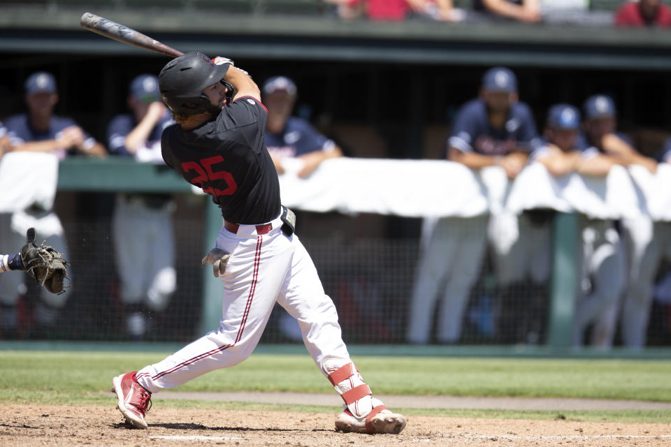 Stanford's Kody Huff follows the flight of his grand slam against Connecticut during the fourth inning of an NCAA college baseball tournament super regional game, Monday, June 13, 2022, in Stanford, Calif. (AP Photo/D. Ross Cameron)