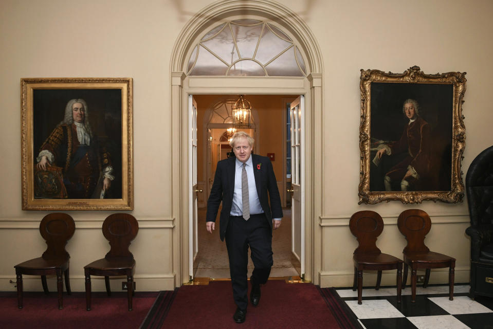 Britain's Prime Minister Boris Johnson walks to leave 10 Downing Street on route to Buckingham Palace ahead of an audience with Queen Elizabeth II and the formal start of the General Election, in London, Wednesday, Nov. 6, 2019. (Stefan Rousseau/Pool Photo via AP)