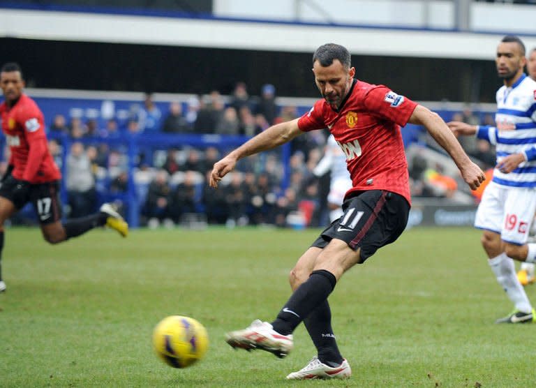 Manchester United Ryan Giggs scores against QPR during their English Premier League football match at Loftus Road in London on February 23, 2012. Manchester United won 2-0