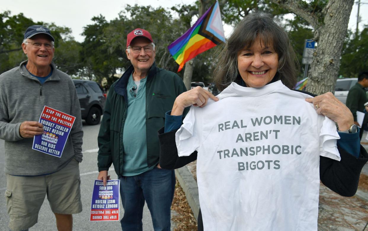 During a demonstration before a Sarasota County School Board meeting, Snow Mowry, of Venice, shows a T-shirt mocking one worn by board member Bridget Ziegler in a social media post, "Real Women Aren't Men."