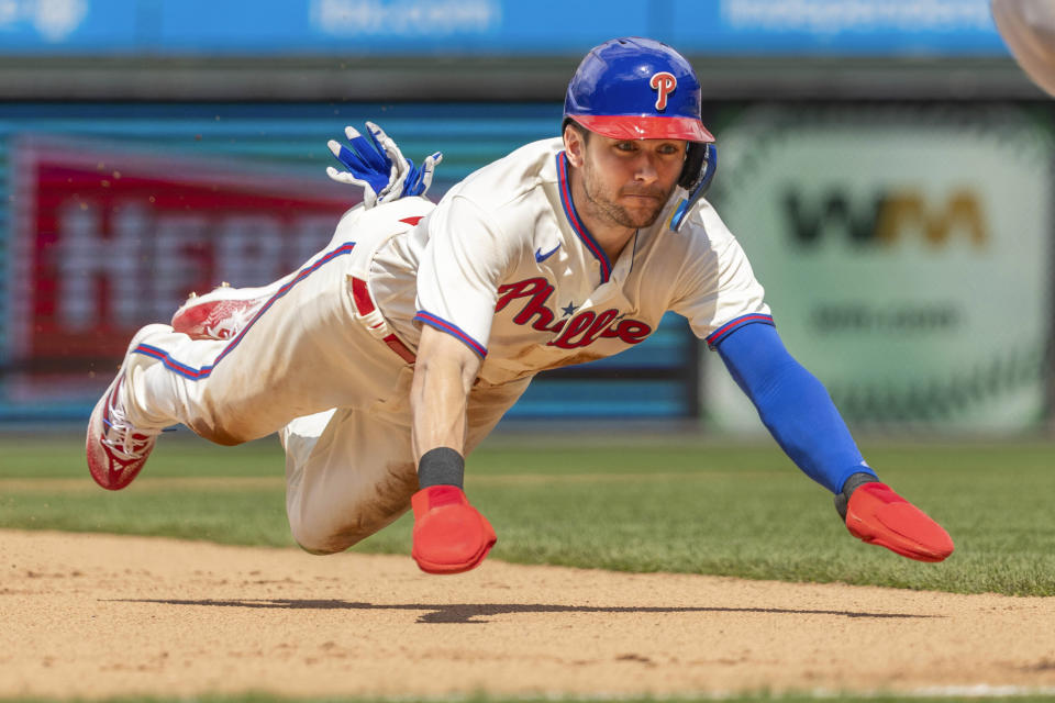 FILE - Philadelphia Phillies' Trea Turner steals third base on his way to score on an RBI by Nick Castellanos during the fifth inning of a baseball game against the New York Mets, Sunday, June 25, 2023, in Philadelphia. The Phillies’ star shortstop set a major league record for most steals in a season without getting caught, going 30-for-30 on the basepaths last year.(AP Photo/Laurence Kesterson, File)