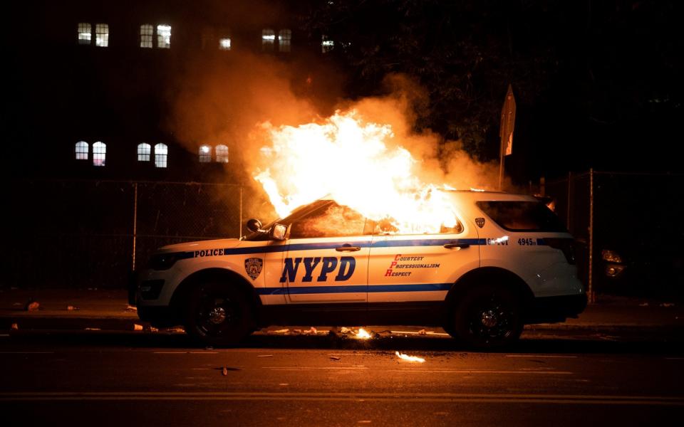 A NYPD police car is set on fire - Jennah Moon/Reuters