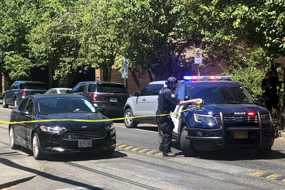 FILE - A police officer tapes off a crime scene on July 22, 2023, after a shooting at Legacy Good Samaritan Medical Center in Portland, Ore. Shootings and other attacks are increasing at hospitals across the U.S., helping to make health care one of the nation's most violent fields. Numbers from the Bureau of Labor Statistics show that American health care workers are now far more likely to suffer nonfatal injuries by violence than workers in any other profession, including law enforcement. (Maxine Bernstein/The Oregonian via AP, File)