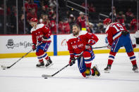 Washington Capitals left wing Alex Ovechkin (8), kneels on the ice during warmups before an NHL hockey game against the New Jersey Devils, Thursday, Jan. 16, 2020, in Washington. (AP Photo/Al Drago)