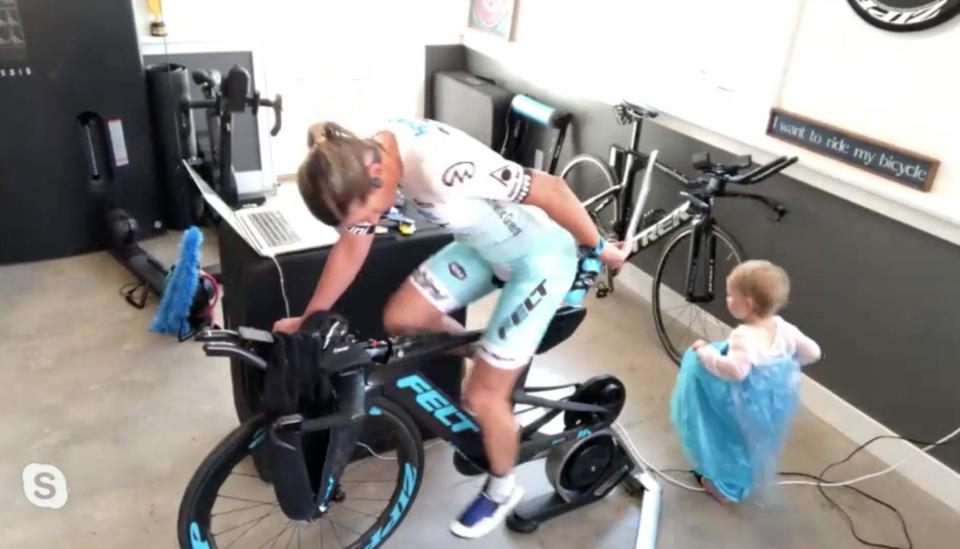 Mirinda Carfrae's toddler amused herself while mom cycled against international champs in the Ironman VR Pro Challenge race. (Photo: Ironman VC)