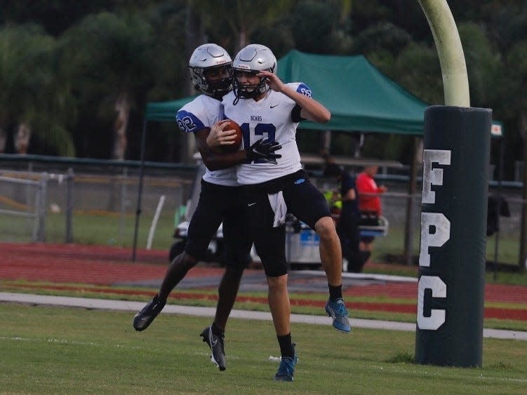 Bartram Trail quarterback Riley Trujillo (12) celebrates a touchdown against Mainland in a preseason summer scrimmage in 2021.