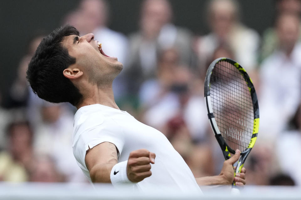 Carlos Alcaraz of Spain celebrates after defeating Daniil Medvedev of Russia in their semifinal match at the Wimbledon tennis championships in London, Friday, July 12, 2024. (AP Photo/Mosa'ab Elshamy)