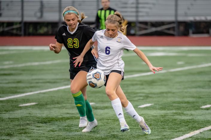 Hickman&#39;s Hattie Hayes (6) plays the ball while trying to get around Rock Bridge&#39;s Izzy Cole (23) during the Bruins&#39; 2-0 win over the Kewpies on Wdnesday at Rock Bridge High School.