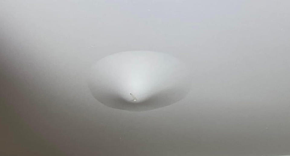 A photo of the ceiling drooping due to excessive water.