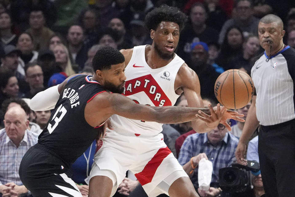 Los Angeles Clippers forward Paul George, left, knocks the ball from the hands of Toronto Raptors forward Thaddeus Young during the first half of an NBA basketball game Wednesday, Jan. 10, 2024, in Los Angeles. (AP Photo/Mark J. Terrill)