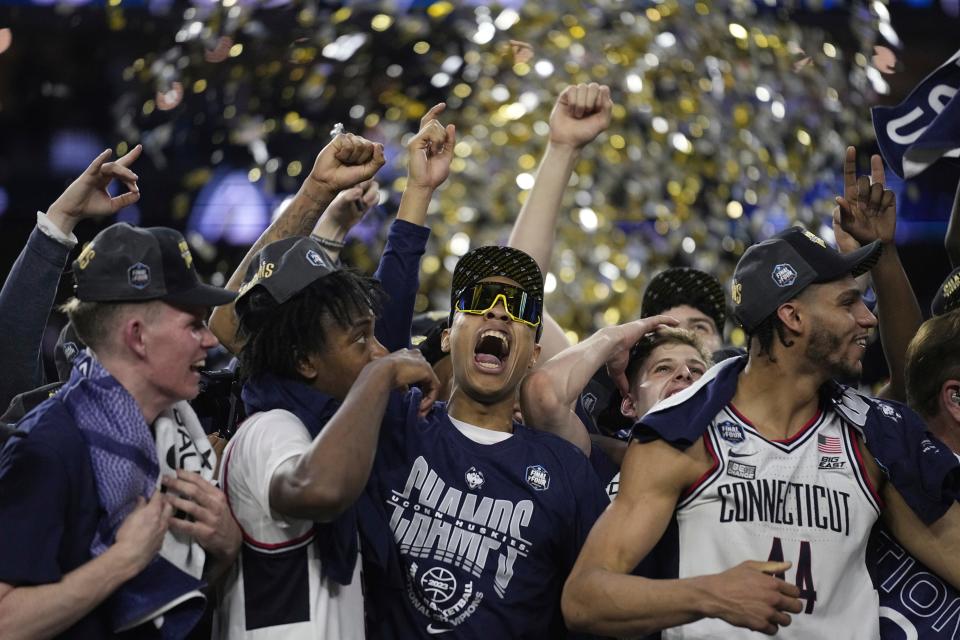 Connecticut players celebrate after the men's national championship college basketball game against San Diego State in the NCAA Tournament on Monday, April 3, 2023, in Houston. (AP Photo/Brynn Anderson)