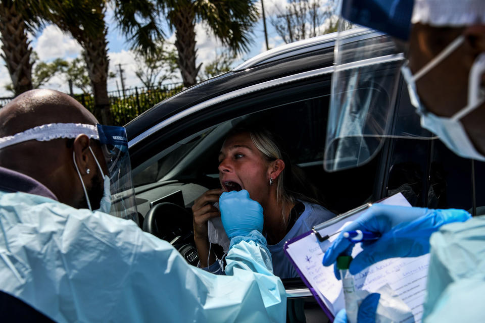 Image: A medical personnel member takes samples of Lee Dinzik at a 