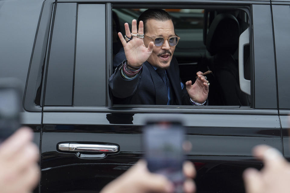 Actor Johnny Depp waves to supporters as he departs the Fairfax County Courthouse Friday, May 27, 2022 in Fairfax, Va. A jury heard closing arguments in Johnny Depp's high-profile libel lawsuit against ex-wife Amber Heard. Lawyers for Johnny Depp and Amber Heard made their closing arguments to a Virginia jury in Depp's civil suit against his ex-wife.(AP Photo/Craig Hudson)