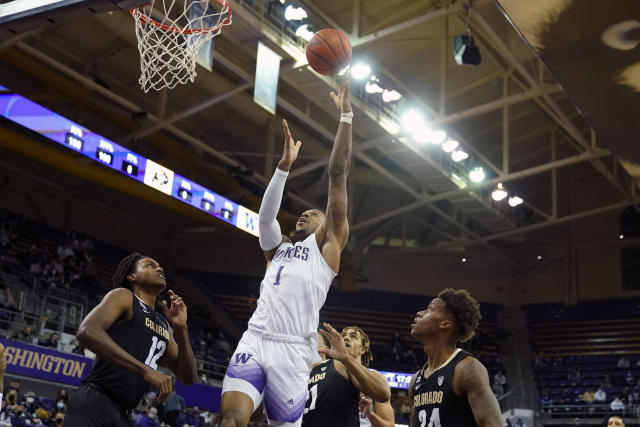 Washington forward Nate Roberts (1) shoots as Colorado forward Jabari Walker (12) looks on during the first half of an NCAA college basketball game, Thursday, Jan. 27, 2022, in Seattle. (AP Photo/Ted S. Warren)
