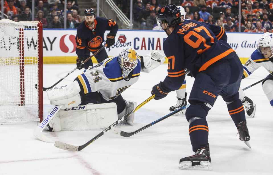 St. Louis Blues' goalie Jake Allen (34) makes the save on Edmonton Oilers' Connor McDavid (97) during the second period of an NHL hockey game Friday, Jan. 31, 2020, in Edmonton, Alberta. (Jason Franson/The Canadian Press via AP)