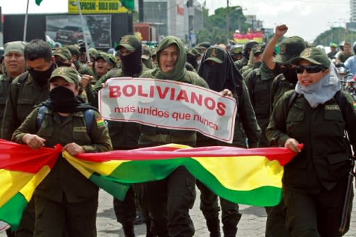 Police officers in Santa Cruz, Bolivia, have joined anti-government protests; they are seen marching on November 9, 2019, carrying a banner that reads 'Bolivians more united than ever'