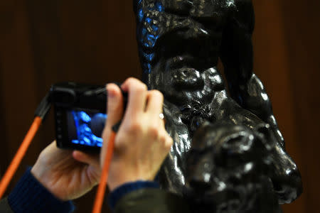 A photographer zooms in on a detail of 'Rothschild Bronzes', confirmed as the only surviving bronze sculpture by Michelangelo, during an event at The Royal Academy of Arts (RA) in London, Britain, November 14, 2018. REUTERS/Dylan Martinez