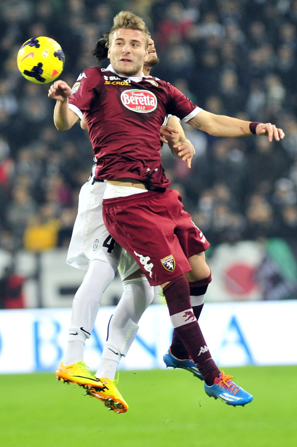 Torino forward Ciro Immobile challenges the ball with Juventus Martin Caceres, of Uruguay, during a Serie A soccer match between Juventus and Torino at the Juventus stadium, in Turin, Italy, Sunday, Feb. 23, 2014. (AP Photo/Massimo Pinca)