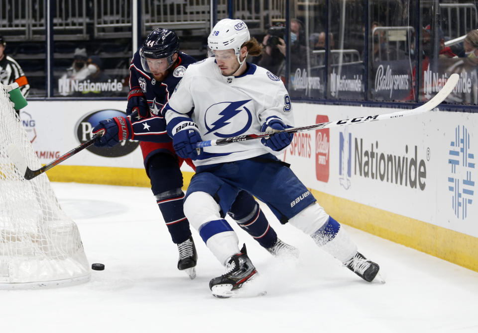 Tampa Bay Lightning defenseman Mikhail Sergachev, right, chases the puck in front of Columbus Blue Jackets defenseman Vladislav Gavrikov during the first period an NHL hockey game in Columbus, Ohio, Thursday, April 8, 2021. (AP Photo/Paul Vernon)