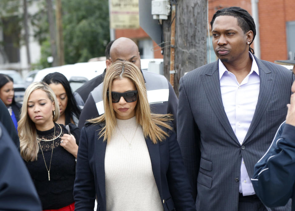 FILE- In this Dec. 7, 2016, file photo, Racquel Smith, widow of former NFL New Orleans Saints football player Will Smith, arrives with family and friends at Orleans Parish Criminal District Court, for the trial of Cardell Hayes in New Orleans. Hayes was convicted of manslaughter Sunday, Dec. 11, in the fatal shooting of Will Smith. (AP Photo/Gerald Herbert, File)