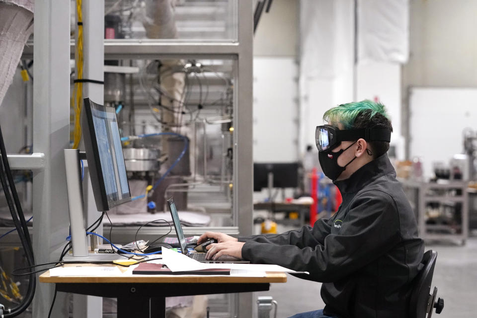 Evan Kline, a test engineer at TerraPower, a company developing and building small nuclear reactors, works on a project there, Thursday, Jan. 13, 2022, in Everett, Wash. In November, Bill Gates' company TerraPower announced it had chosen Kemmerer, Wy., for a nontraditional, sodium-cooled nuclear reactor that will bring on workers from a local coal-fired power plant scheduled to close soon. The project comes as many U.S. states see nuclear emerging as an answer to fill the gap as a transition away from coal, oil and natural gas to reduce greenhouse gas emissions. (AP Photo/Elaine Thompson)