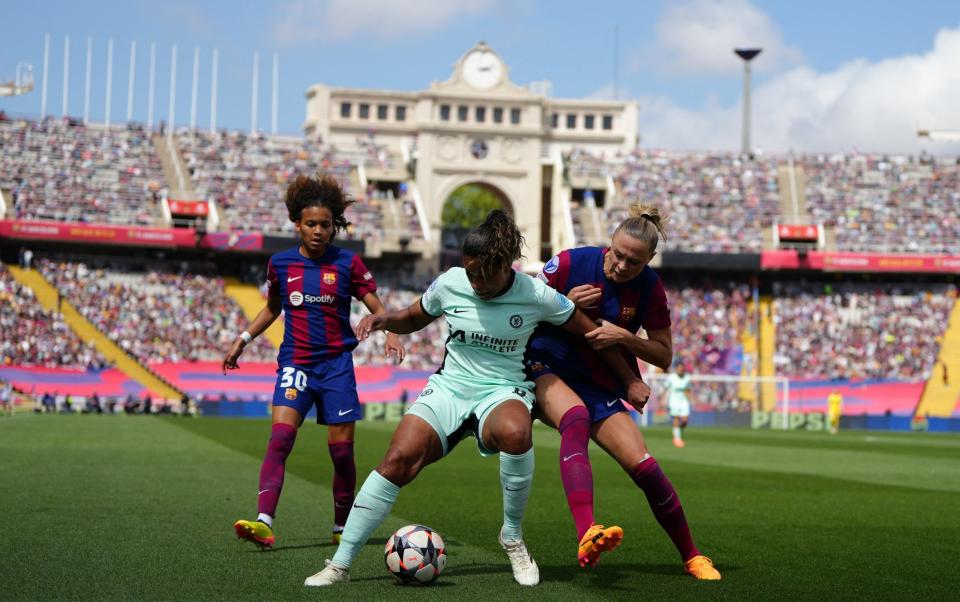 Catarina Macario (C) is challenged by Barcelona's Spanish forward Victoria Lopez and Barcelona's Swedish forward Fridolina Rolfo