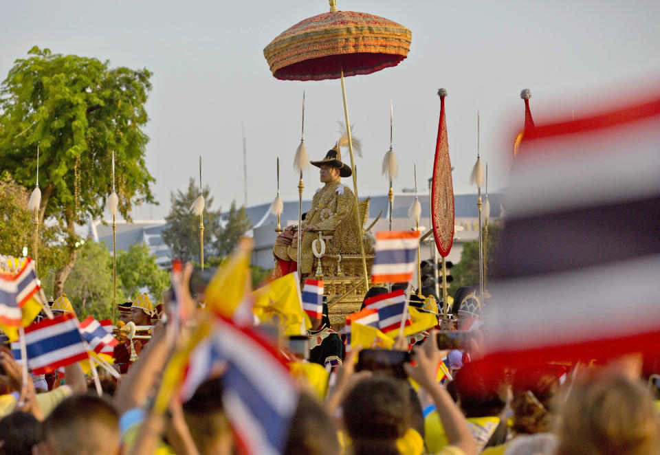 Thailand’s King Maha Vajiralongkorn is carried on a palanquin through the streets outside the Grand Palace for the public to pay homage to him on the second day of his coronation ceremony in Bangkok, Sunday, May 5, 2019. Vajiralongkorn was officially crowned Saturday amid the splendor of the country's Grand Palace, taking the central role in an elaborate centuries-old royal ceremony that was last held almost seven decades ago. (AP Photo/Gemunu Amarasinghe)