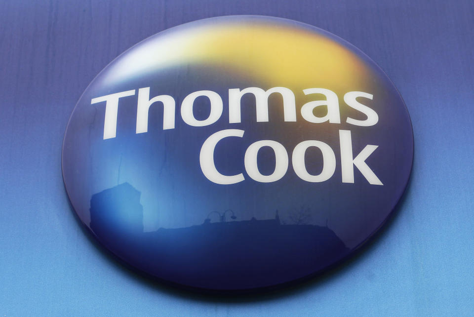 FILE - In this Tuesday, Nov. 22, 2011 file photo, a sign of Thomas Cook travel agent is seen at a branch in north London. More than 600,000 vacationers who booked through tour operator Thomas Cook were on edge Sunday, wondering if they will be able to get home, as one of the world's oldest and biggest travel companies teetered on the edge of collapse. The debt-laden company, which confirmed Friday it was seeking 200 million pounds ($250 million) in funding to avoid going bust, was in talks with shareholders and creditors to stave off failure. (AP Photo/Sang Tan, File)