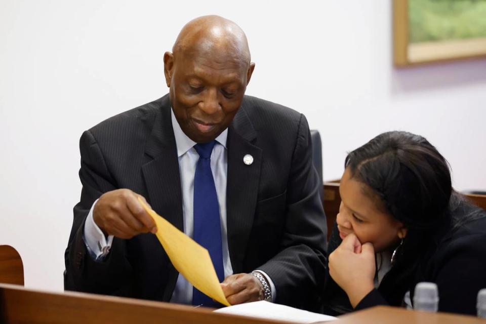 Rep. Shelly Willingham and his granddaughter Chandler Hinton, 11, look over forms before the opening session of the N.C. House of Representatives Wednesday, Jan. 11, 2023.