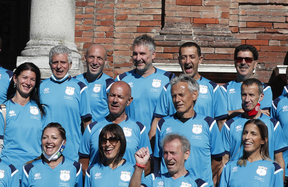 Mattia Maestri, top row, third from left, poses for a group photo prior to the start of a 180-kilometer relay race, in Codogno, Italy, Saturday, Sept. 26, 2020. Italy’s coronavirus Patient No. 1, whose case confirmed one of the world’s deadliest outbreaks was underway, is taking part in a 180-kilometer relay race as a sign of hope for COVID victims after he himself recovered from weeks in intensive care. Mattia Maestri, a 38-year-old Unilever manager, was suited up Saturday for the start of the two-day race between Italy’s first two virus hotspots. It began in Codogno, where Maestri tested positive Feb. 21, and was ending Sunday in Vo’Euganeo, where Italy’s first official COVID death was recorded the same day. (AP Photo/Antonio Calanni)