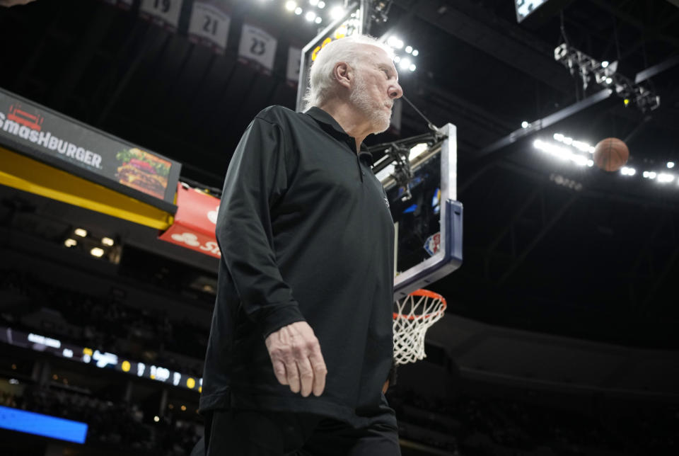 San Antonio Spurs coach Gregg Popovich heads to the bench before the team's NBA basketball game against the Denver Nuggets on Friday, Oct. 22, 2021, in Denver. (AP Photo/David Zalubowski)