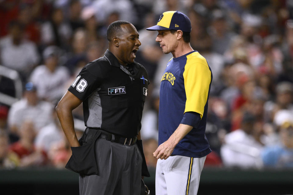 Milwaukee Brewers manager Craig Counsell, right, listens to home plate umpire Ramon De Jesus during an argument in the fifth inning of the team's baseball game against the Washington Nationals, Friday, June 10, 2022, in Washington. Counsell was ejected. (AP Photo/Nick Wass)