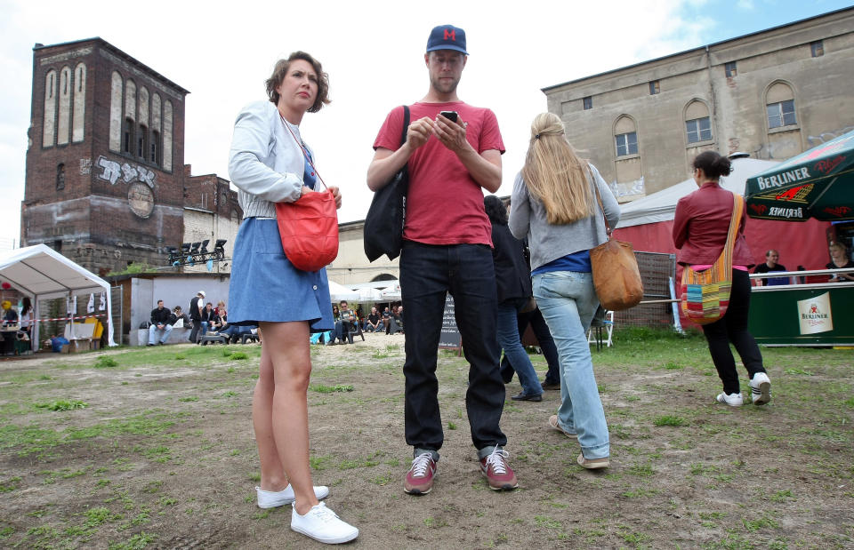 BERLIN, GERMANY - JULY 21: Attendees wait for the start of the games at the second annual Hipster Olympics on July 21, 2012 in Berlin, Germany. With events such as the "Horn-Rimmed Glasses Throw," "Skinny Jeans Tug-O-War," "Vinyl Record Spinning Contest" and "Cloth Tote Sack Race," the Hipster Olympics both mocks and celebrates the Hipster subculture, which some critics claim could never be accurately defined and others that it never existed in the first place. The imprecise nature of determining what makes one a member means that the symptomatic elements of adherants to the group vary in each country, but the archetype of the version in Berlin, one of the more popular locations for those following its lifestyle, along with London and Brooklyn, includes a penchant for canvas tote bags, the carbonated yerba mate drink Club Mate, analogue film cameras, asymetrical haircuts, 80s neon fashion, and, allegedly, a heavy dose of irony. To some in Berlin, members of the hipster "movement" have replaced a former unwanted identity in gentrifying neighborhoods, the Yuppie, for targets of criticism, as landlords raise rents in the areas to which they relocate, particularly the up-and-coming neighborhood of Neukoelln. (Photo by Adam Berry/Getty Images)