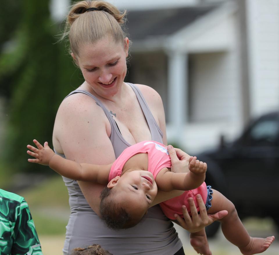 Sara Kurzinsky holds her youngest child, 10-month-old Halo Cooper, before breaking ground Monday, June 17, 2024, on their new home at Green Avenue and Noble Street.