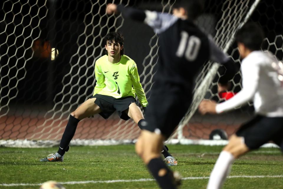 Palm Springs goalkeeper Tyler Bloomer (1) eyes the ball as Shadow Hills midfielder Alex Cervantes (10) prepares to take a shot on goal in Indio, Calif., on Thurs., December 21, 2023.