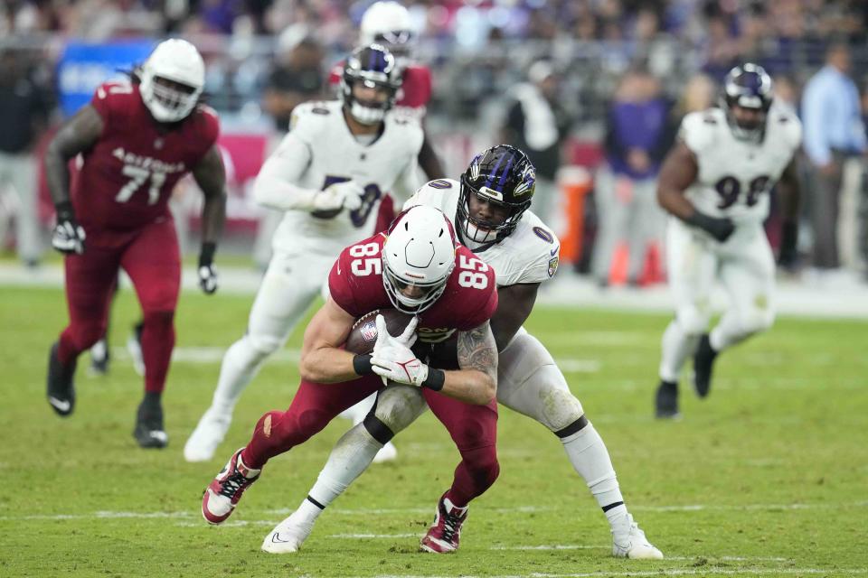Arizona Cardinals tight end Trey McBride (85) is stopped by Baltimore Ravens linebacker Roquan Smith (0) during the second half of an NFL football game Sunday, Oct. 29, 2023, in Glendale, Ariz. (AP Photo/Ross D. Franklin)