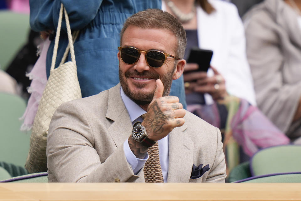 David Beckham gestures as watches the first round match on Centre Court between defending champion Carlos Alcaraz of Spain and Mark Lajal of Estonia at the Wimbledon tennis championships in London, Monday, July 1, 2024. (AP Photo/Alberto Pezzali)