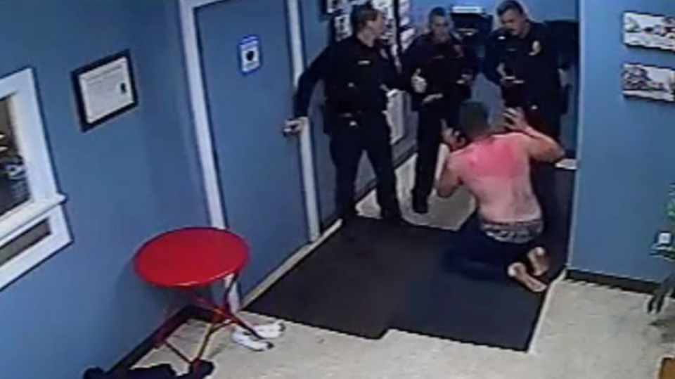 In this screenshot from video, Jason Jones is seen in the lobby of a Catskill police station. Jones became engulfed in flames when an officer used a Taser on him after he doused himself in flammable hand sanitizer on October 30, 2021. / Credit: New York Attorney General's Office