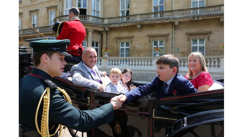 A young boy with his family in a carriage