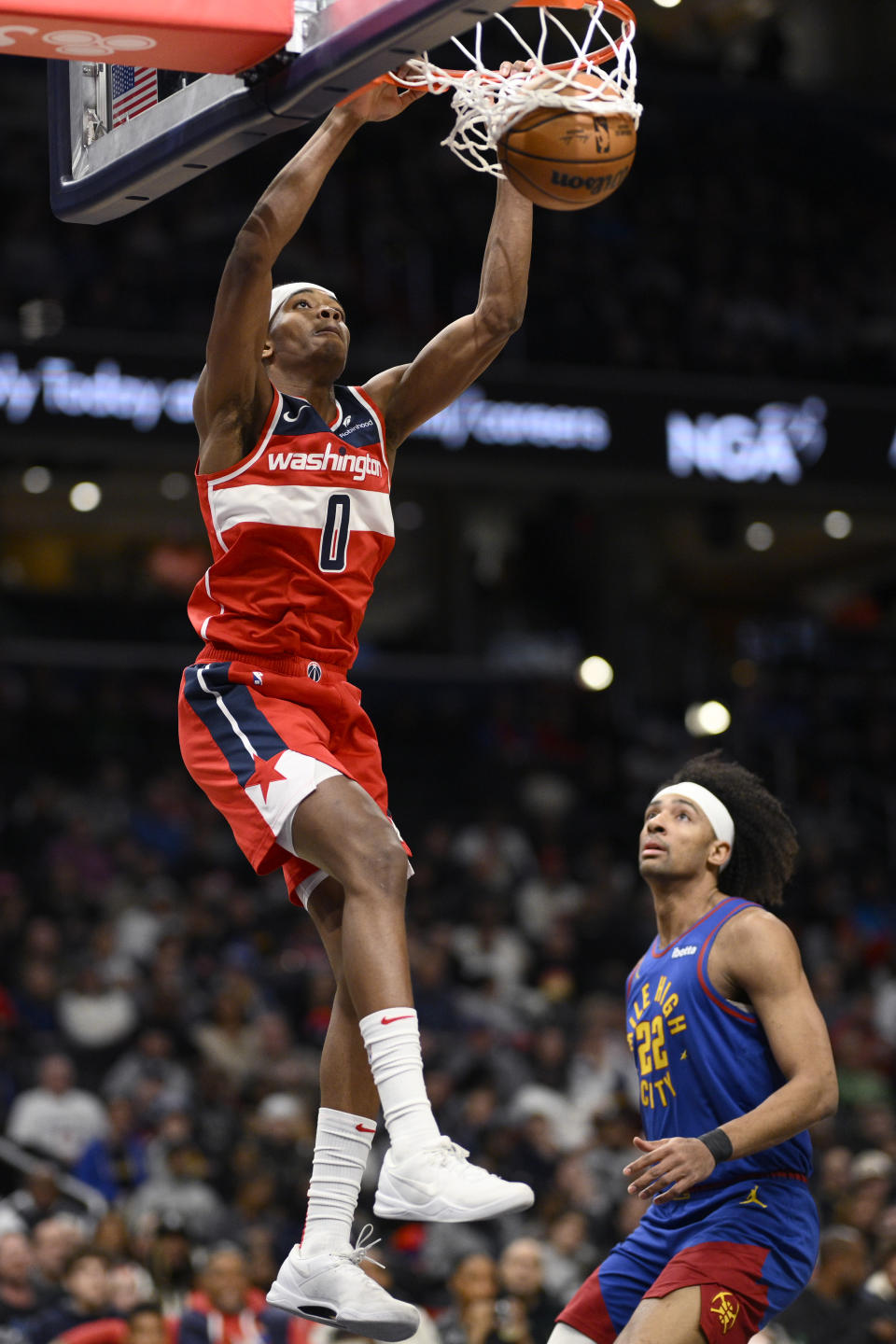 Washington Wizards guard Bilal Coulibaly (0) dunks over Denver Nuggets forward Zeke Nnaji (22) during the first half of an NBA basketball game, Sunday, Jan. 21, 2024, in Washington. (AP Photo/Nick Wass)