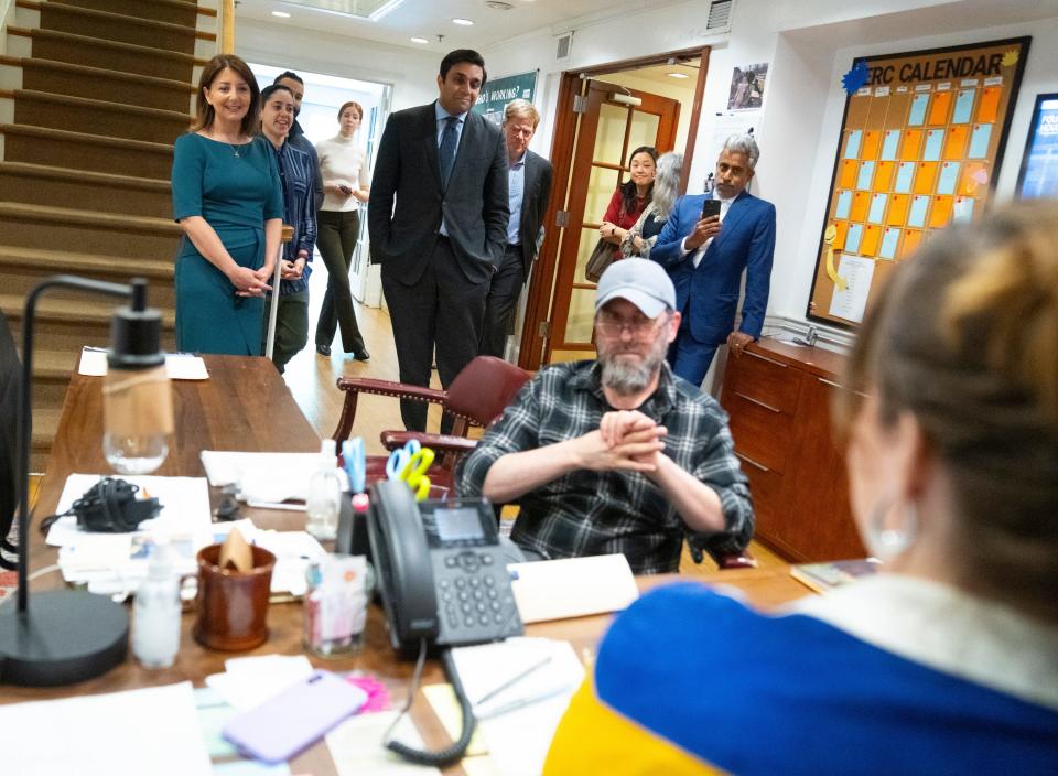 Fountain House member Jonathan Geller gets advice from a staff member while Dr. Mandy Cohen, director of the Centers for Disease Control and Prevention, left, and New York City Health Commissioner Dr. Ashwin Vasan, center, observe on May 14, 2024, in New York City.